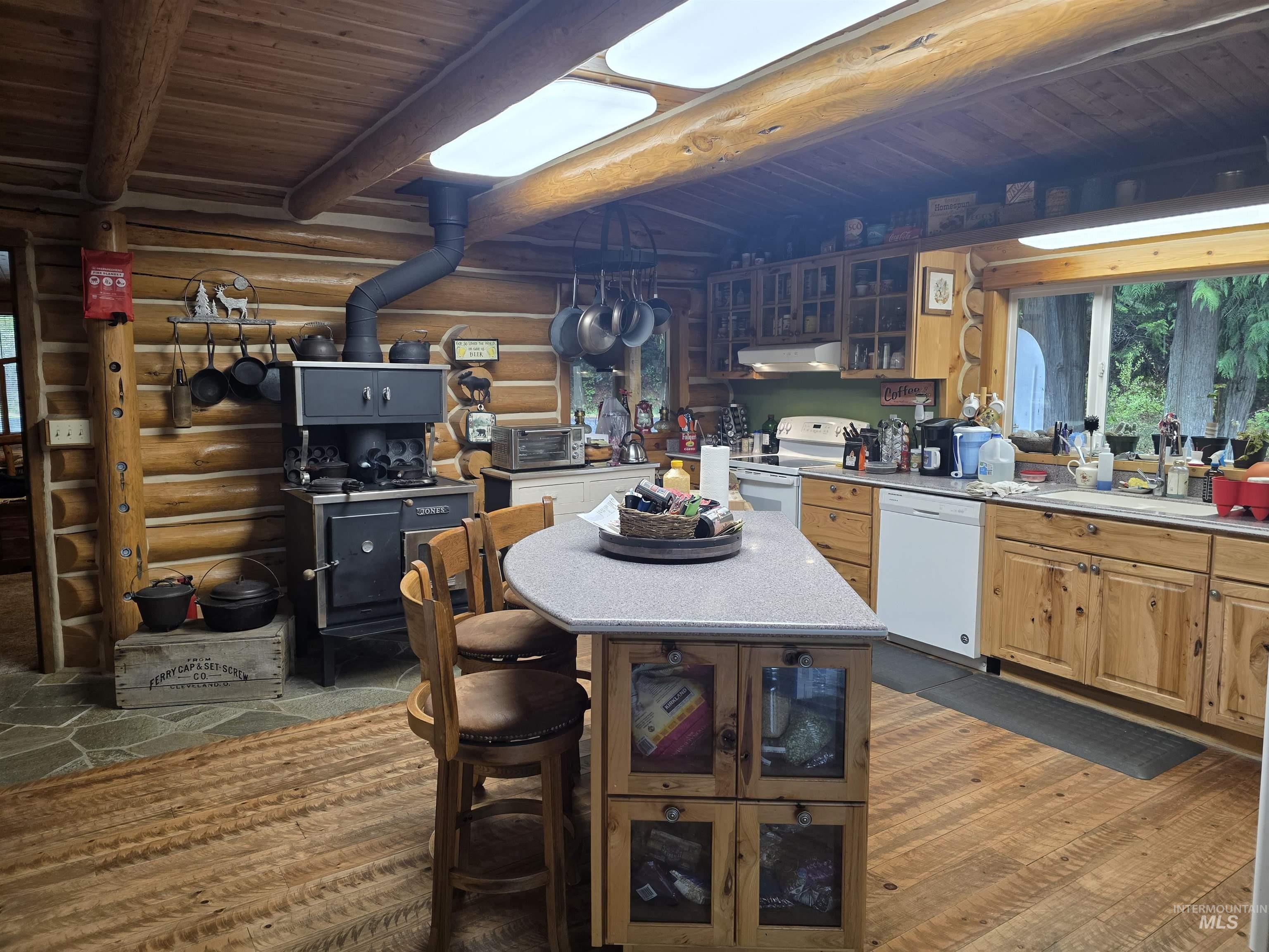 112 Three Forks Road Kamiah, ID 83536 - Photo 13 of 45 Rustic kitchen featuring log walls and ceiling beams