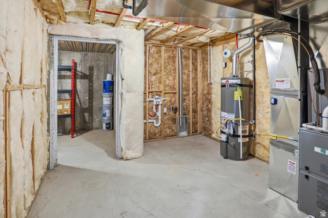 3636 West 910 South Syracuse, UT 84075 - Photo 55 of 70 Unfinished basement featuring exposed wood framing, concrete flooring, visible insulation, and essential utility systems