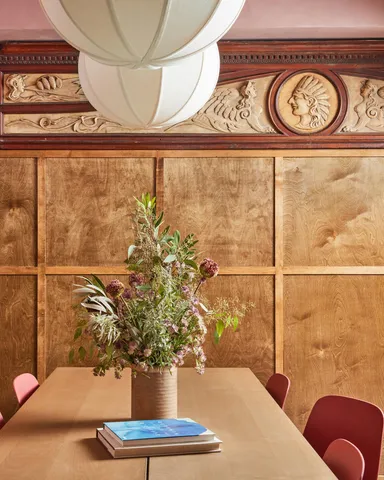 a view of a room with a chair and potted plant