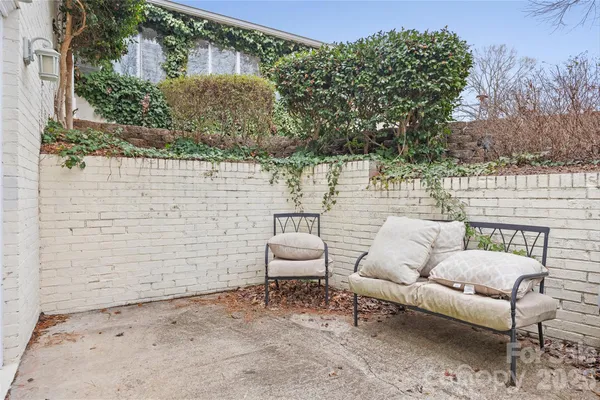 a view of a house with a yard and sitting area