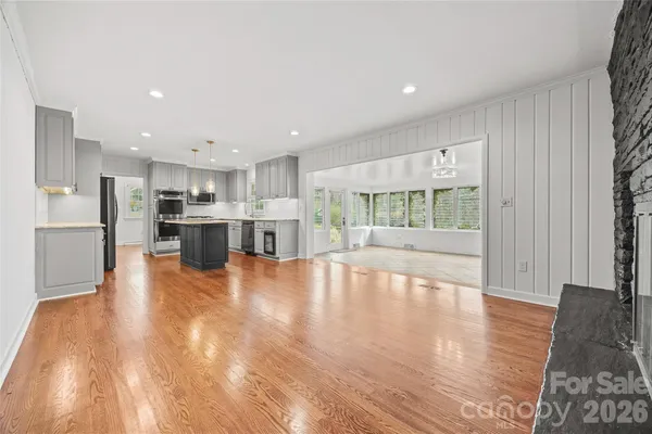 a view of kitchen with wooden floor and refrigerator