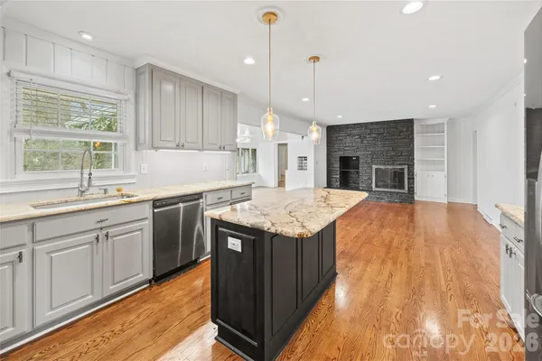 a kitchen with a stove sink and cabinets