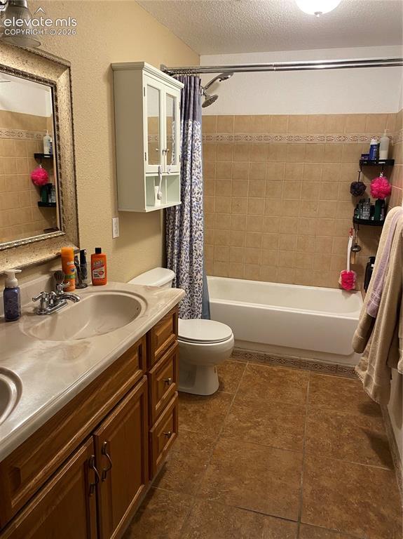 9362 St.George Road Peyton, CO 80831 - Photo 26 of 32 a bathroom with a granite countertop sink a toilet and shower