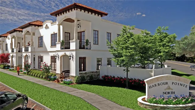 a large white building with a clock tower in the middle in front of it