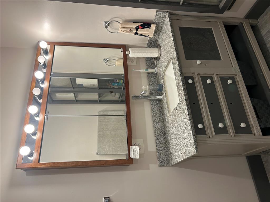 7 Allegheny Road Mount Bethel, PA 18343 - Photo 64 of 71 Fine granite countertops and detailed wooden cabinetry define this bathroom vanity area.