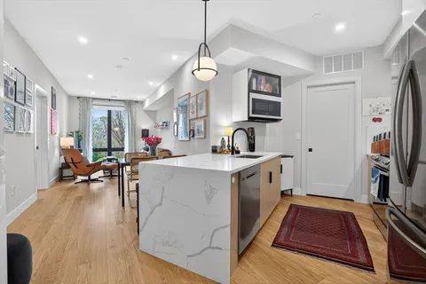 a kitchen with sink a refrigerator and a stove