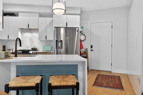 a kitchen with cabinets and refrigerator