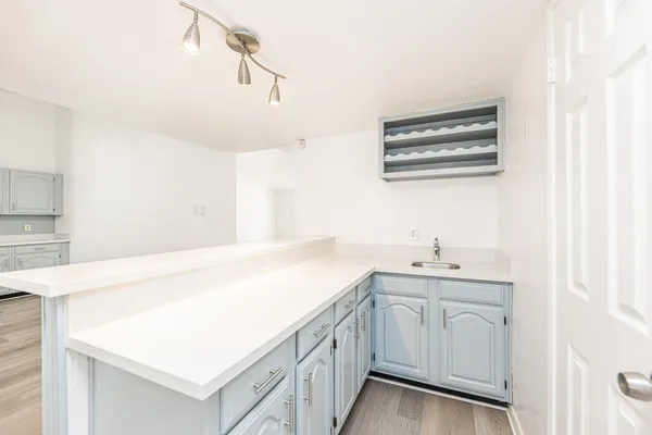 a large kitchen with stainless steel appliances lots of counter space sink and cabinets