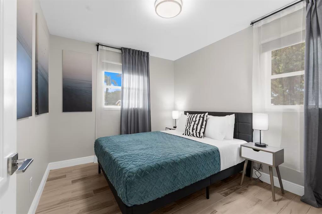 8215 Quail Road Seminole, FL 33777 - Photo 11 of 25 a bedroom with a bed and with a mirror