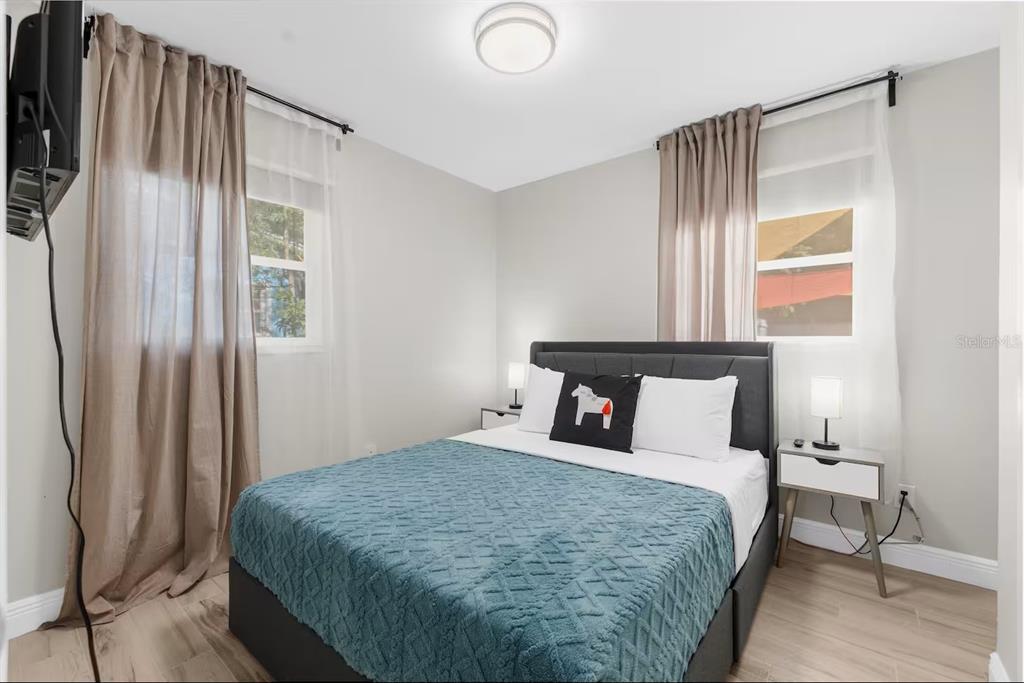 8215 Quail Road Seminole, FL 33777 - Photo 13 of 25 a bedroom with a bed and a window