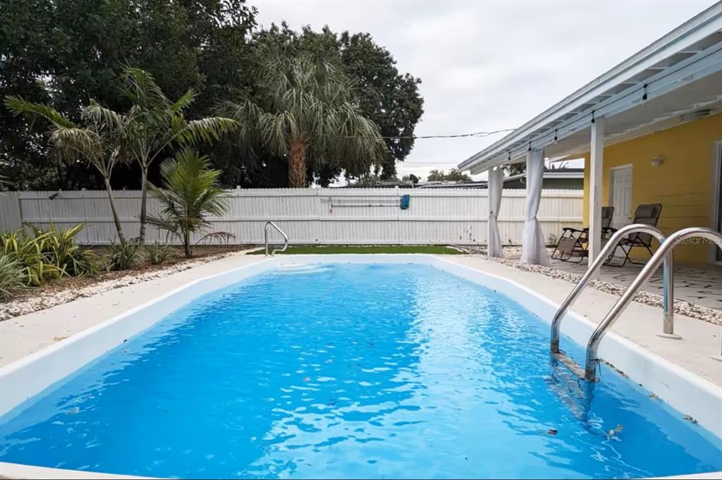 8215 Quail Road Seminole, FL 33777 - Photo 21 of 25 a view of a swimming pool with a patio