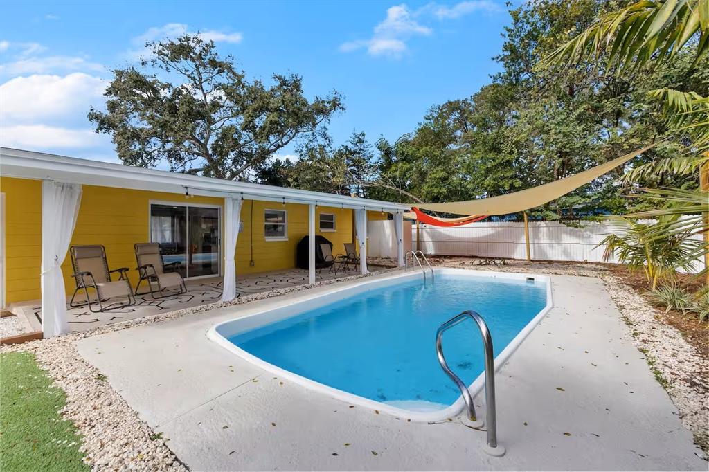 8215 Quail Road Seminole, FL 33777 - Photo 22 of 25 a view of a swimming pool with a patio