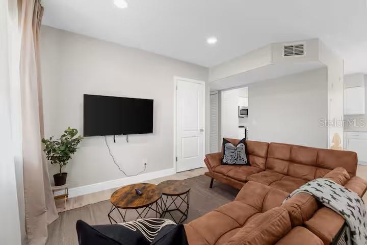 8215 Quail Road Seminole, FL 33777 - Photo 3 of 25 a living room with furniture and a flat screen tv
