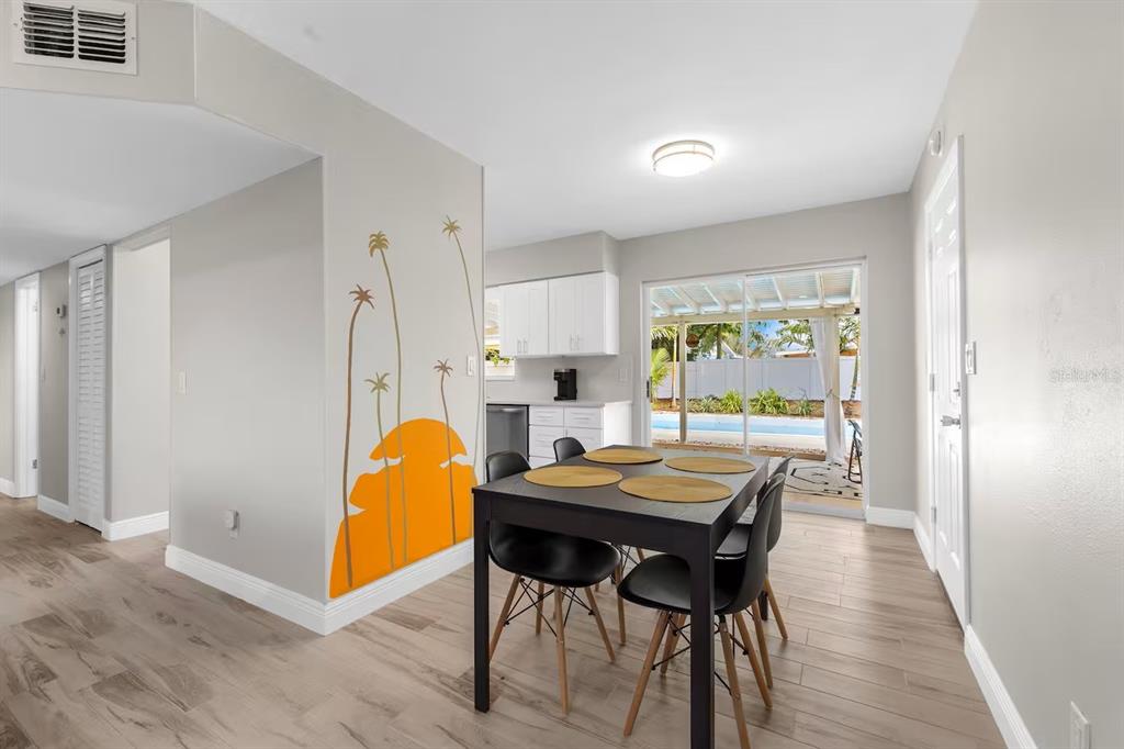 8215 Quail Road Seminole, FL 33777 - Photo 8 of 25 a view of a dining room with furniture and wooden floor