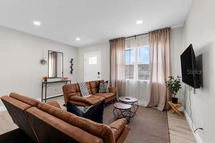 8215 Quail Road Seminole, FL 33777 - Photo 9 of 25 a living room with furniture and a flat screen tv