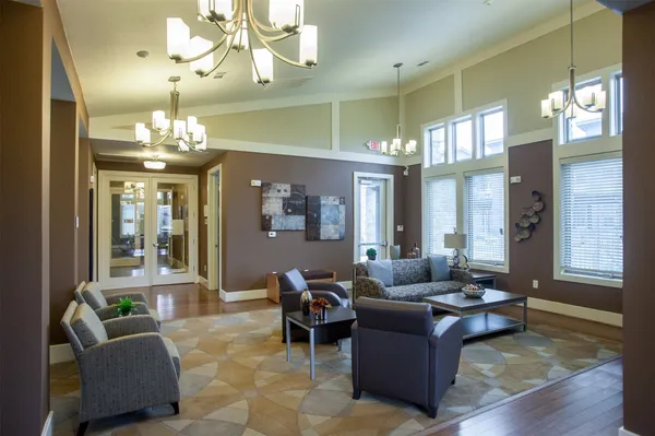 a living room with furniture and a chandelier