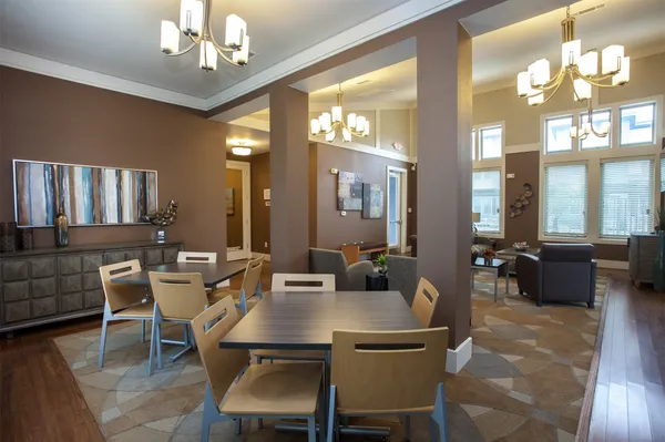 a view of a dining room with furniture and chandelier