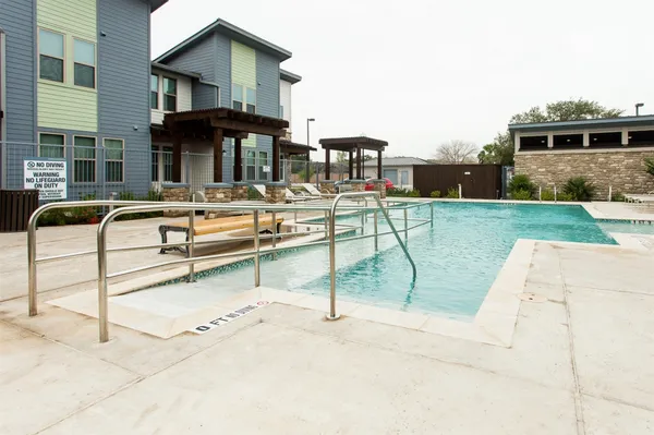 a view of a house with pool porch and chairs
