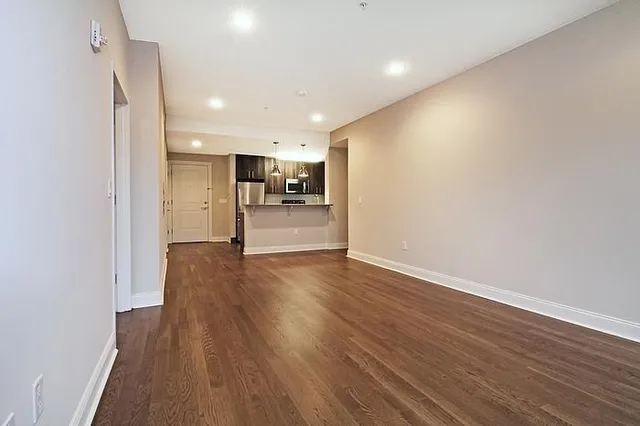 a view of a kitchen with a sink and wooden floor
