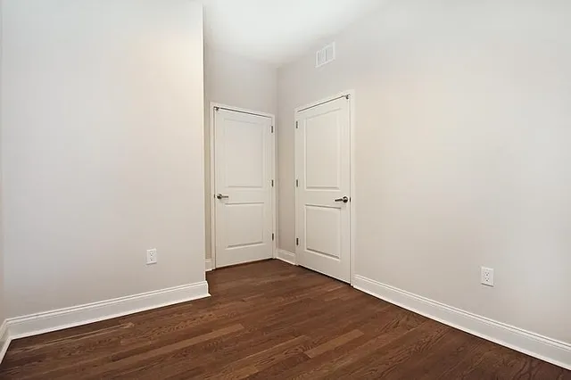 an empty room with wooden floor