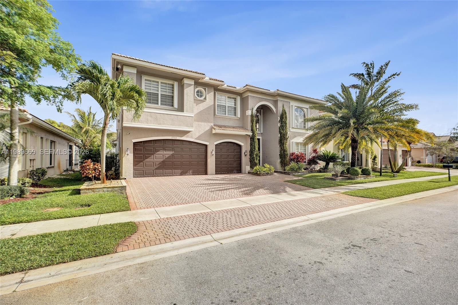 17713 Southwest 47th Street Miramar, FL 33029 - Photo 2 of 94 a front view of a house with a yard and garage