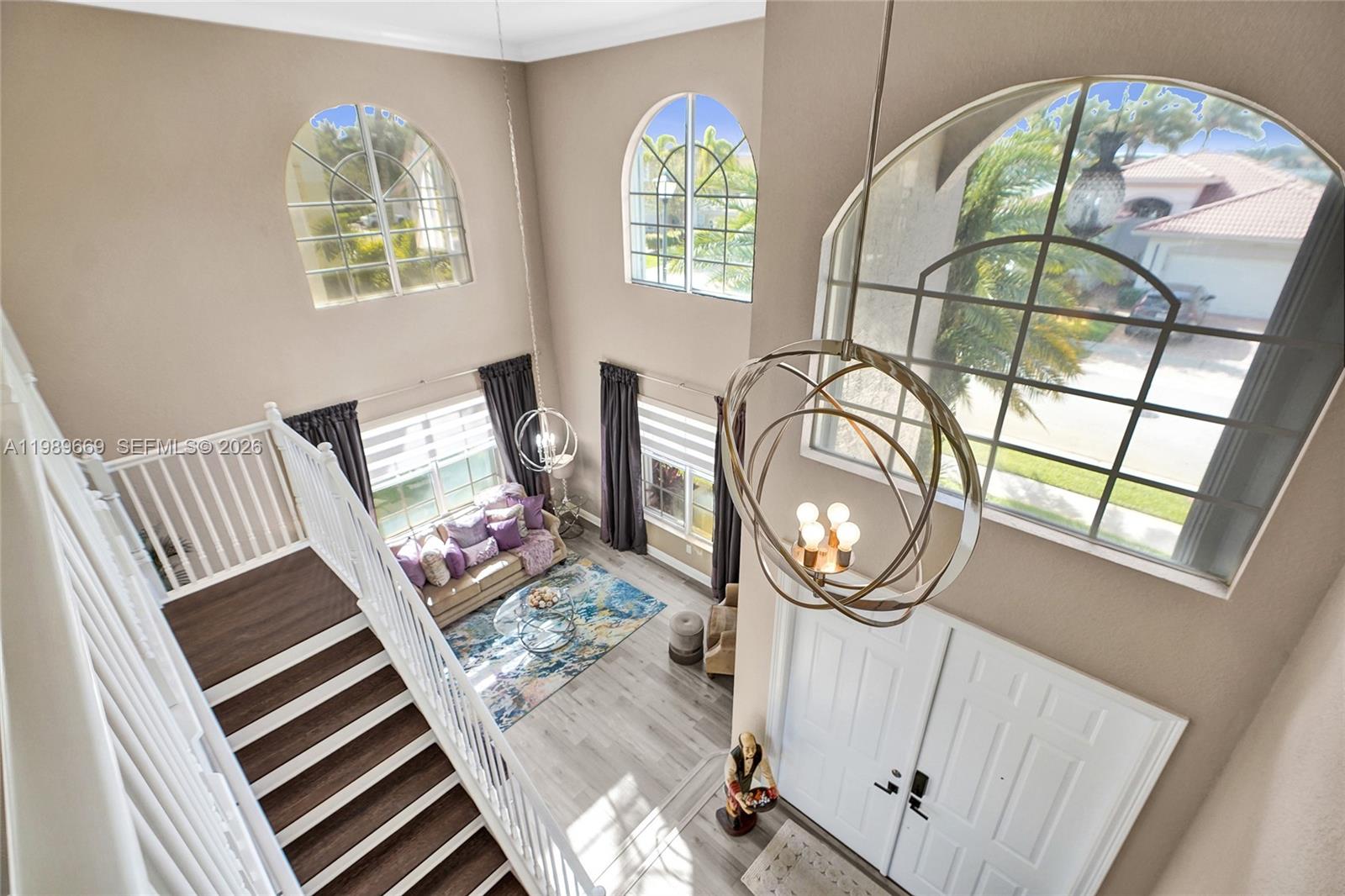 17713 Southwest 47th Street Miramar, FL 33029 - Photo 23 of 94 a view of a livingroom with furniture wooden floor windows and a chandelier