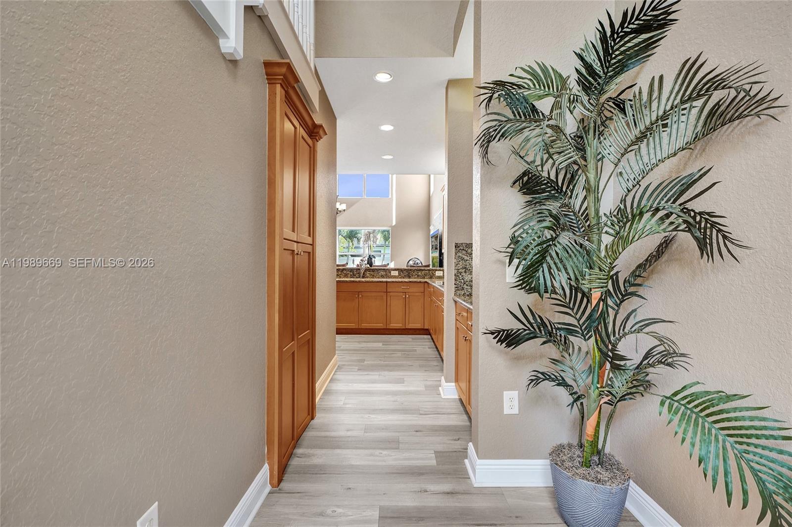17713 Southwest 47th Street Miramar, FL 33029 - Photo 25 of 94 a view of a hallway with potted plants and wooden floor