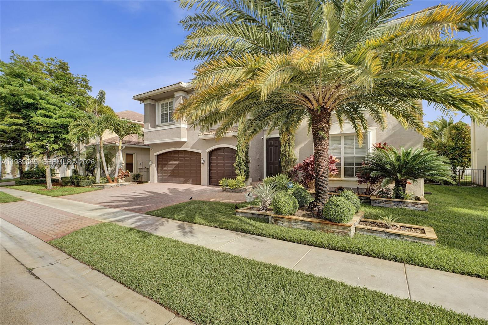 17713 Southwest 47th Street Miramar, FL 33029 - Photo 3 of 94 a front view of a house with garden and sitting area