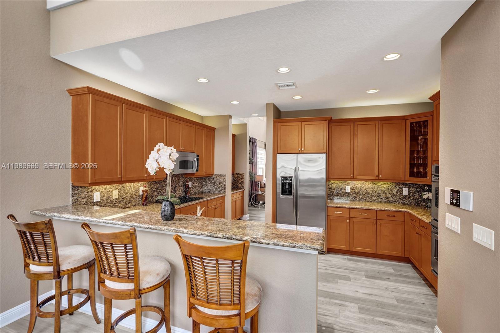 17713 Southwest 47th Street Miramar, FL 33029 - Photo 31 of 94 a kitchen with stainless steel appliances granite countertop a stove a sink and a refrigerator