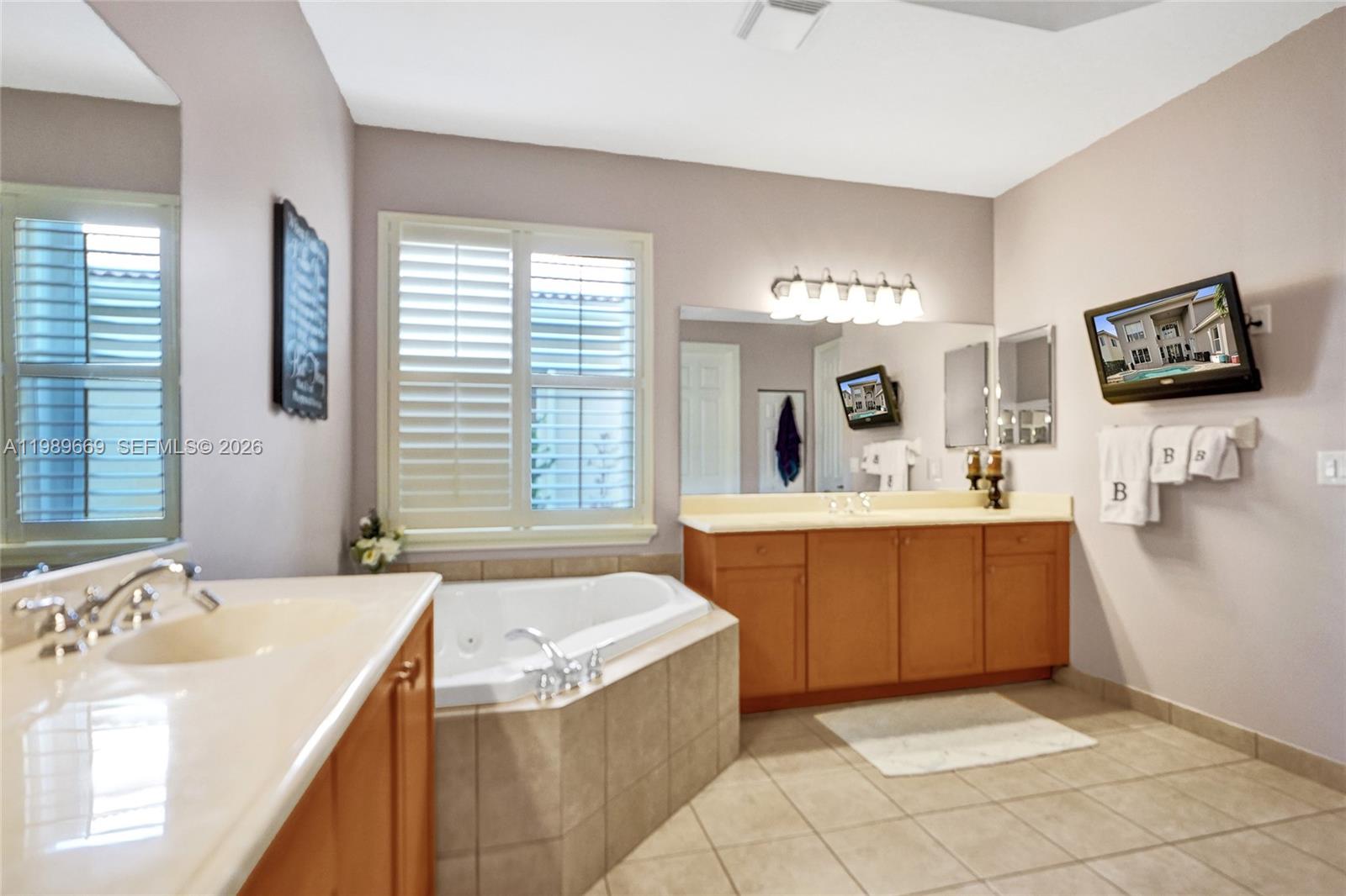 17713 Southwest 47th Street Miramar, FL 33029 - Photo 39 of 94 a spacious bathroom with a tub sink and mirror