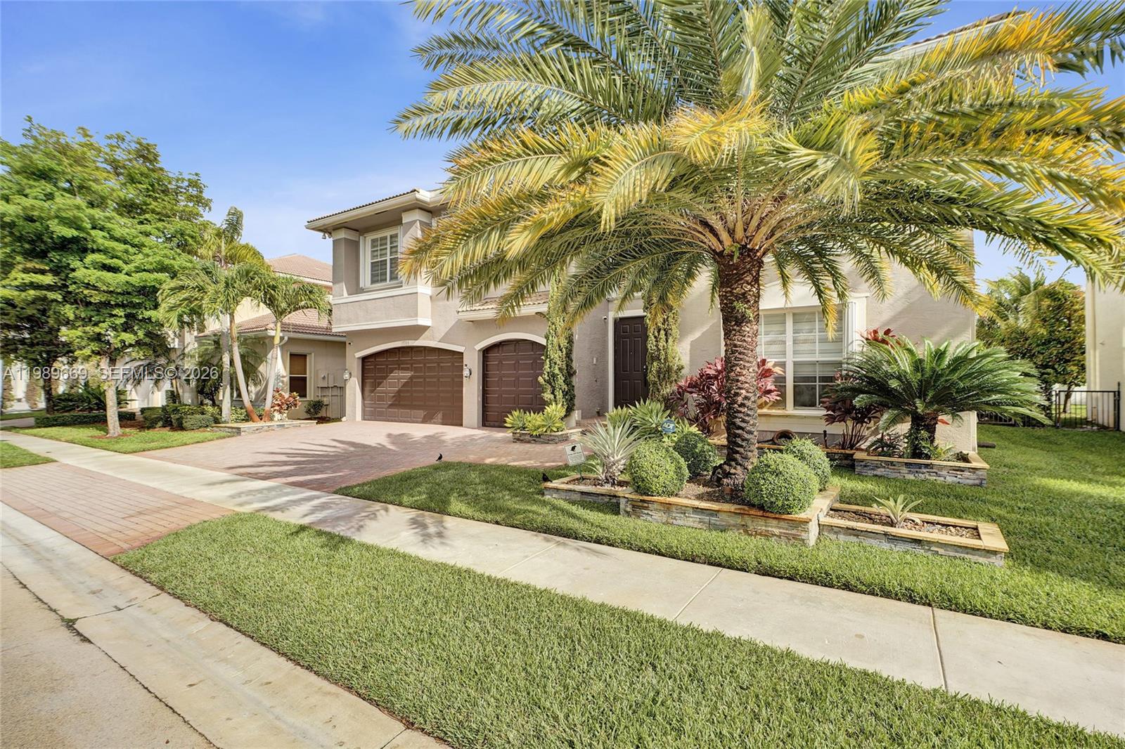 17713 Southwest 47th Street Miramar, FL 33029 - Photo 79 of 94 a front view of a house with garden and sitting area