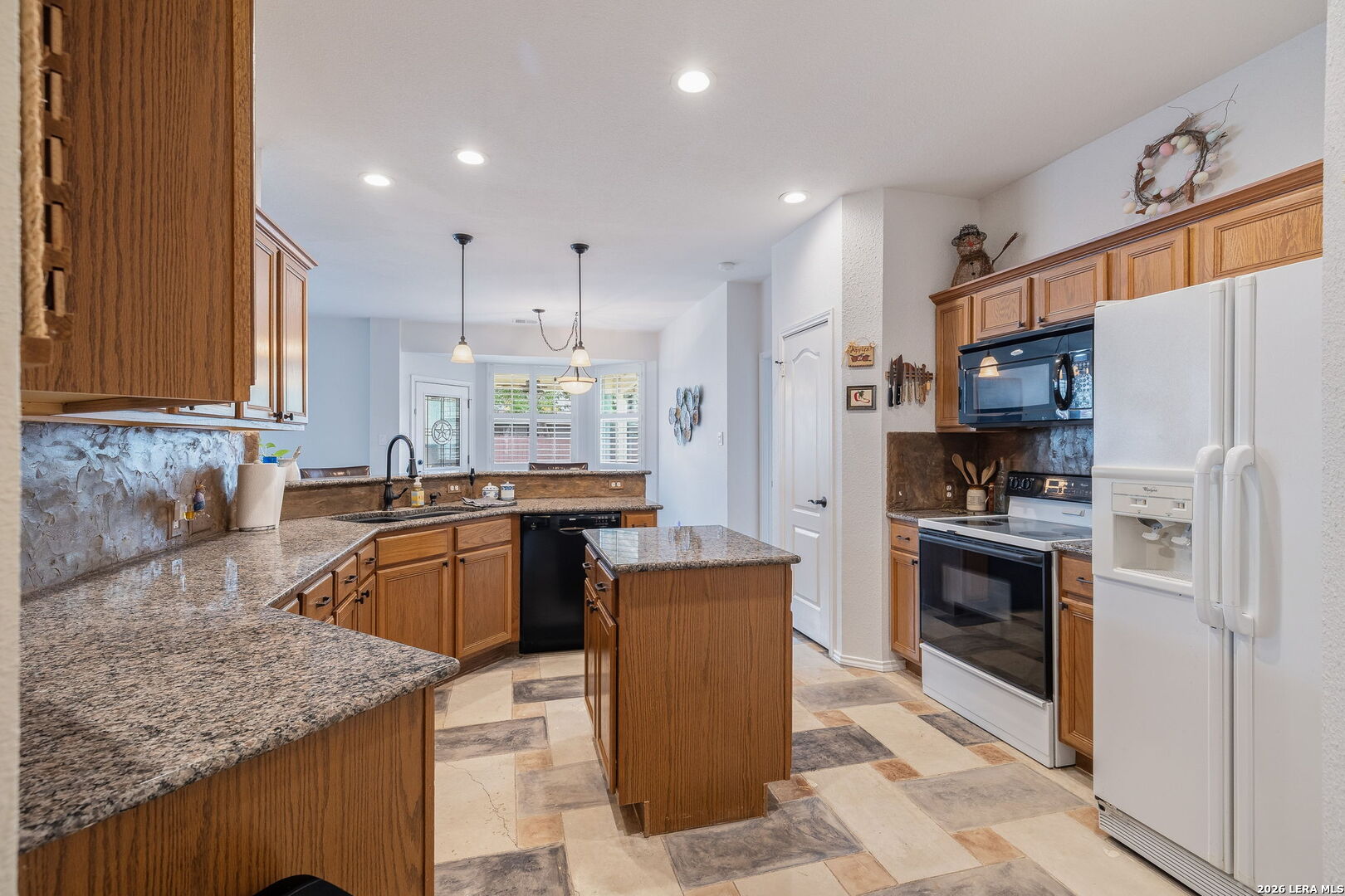 229 Notch Leaf Cibolo, TX 78108 - Photo 17 of 30 a kitchen with stainless steel appliances granite countertop a sink stove and refrigerator