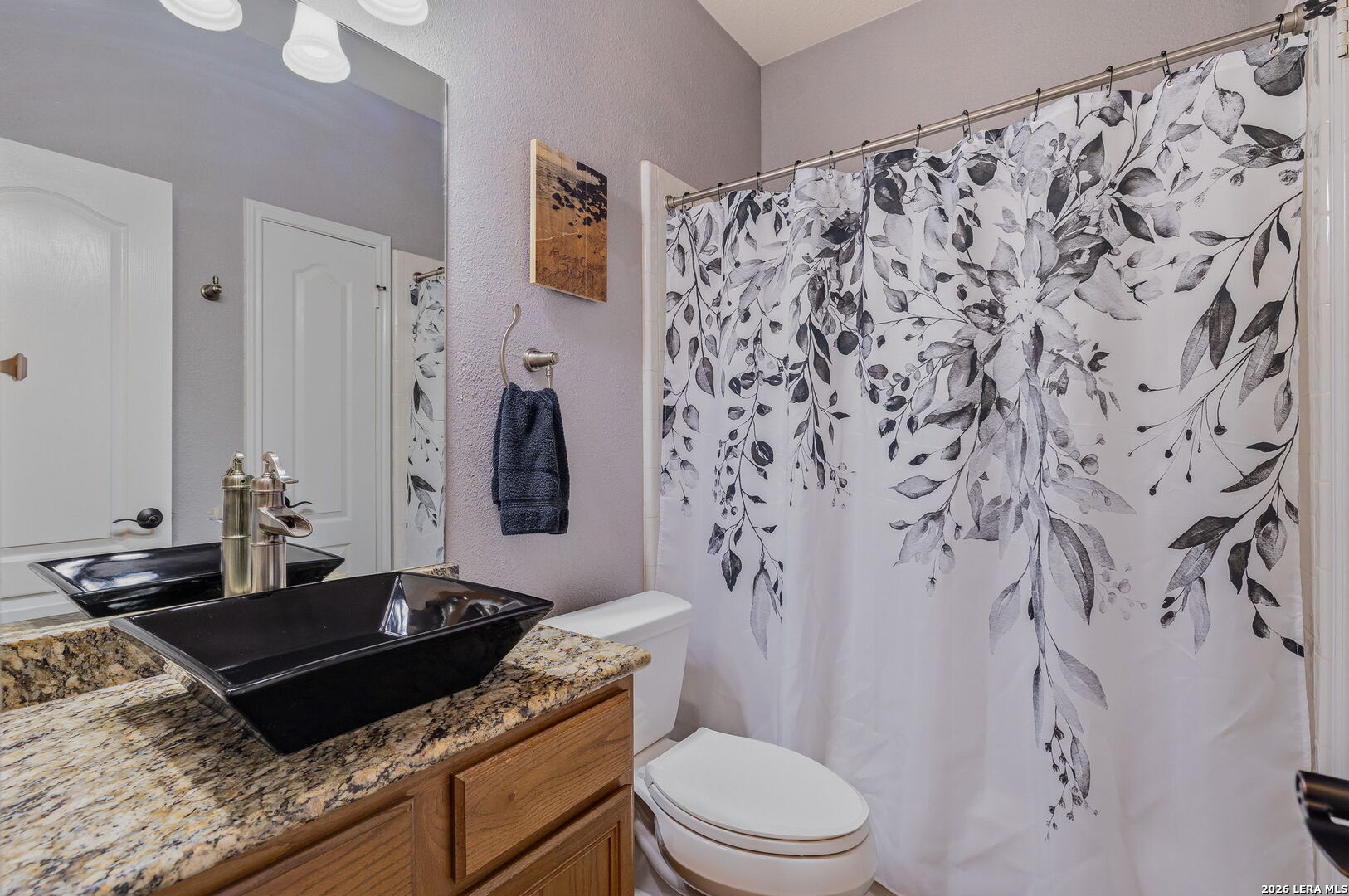 229 Notch Leaf Cibolo, TX 78108 - Photo 8 of 30 a bathroom with a granite countertop sink a toilet and a shower curtain