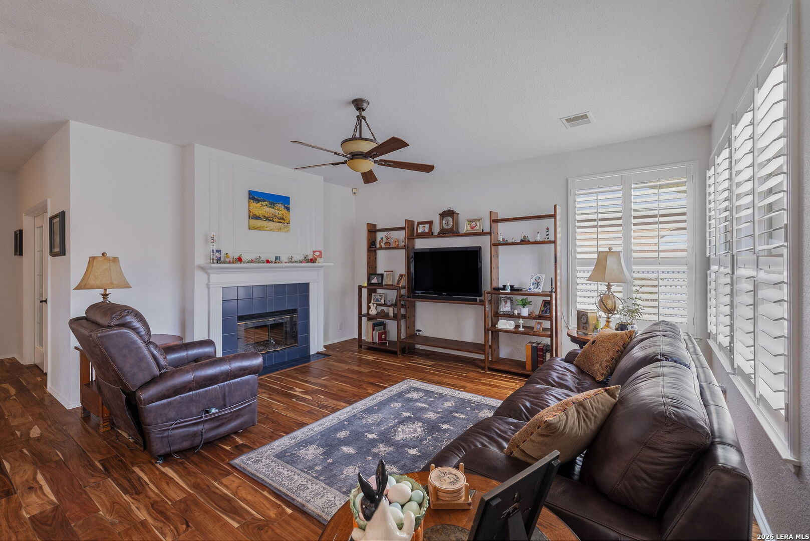 229 Notch Leaf Cibolo, TX 78108 - Photo 9 of 30 a living room with furniture a flat screen tv and a fireplace