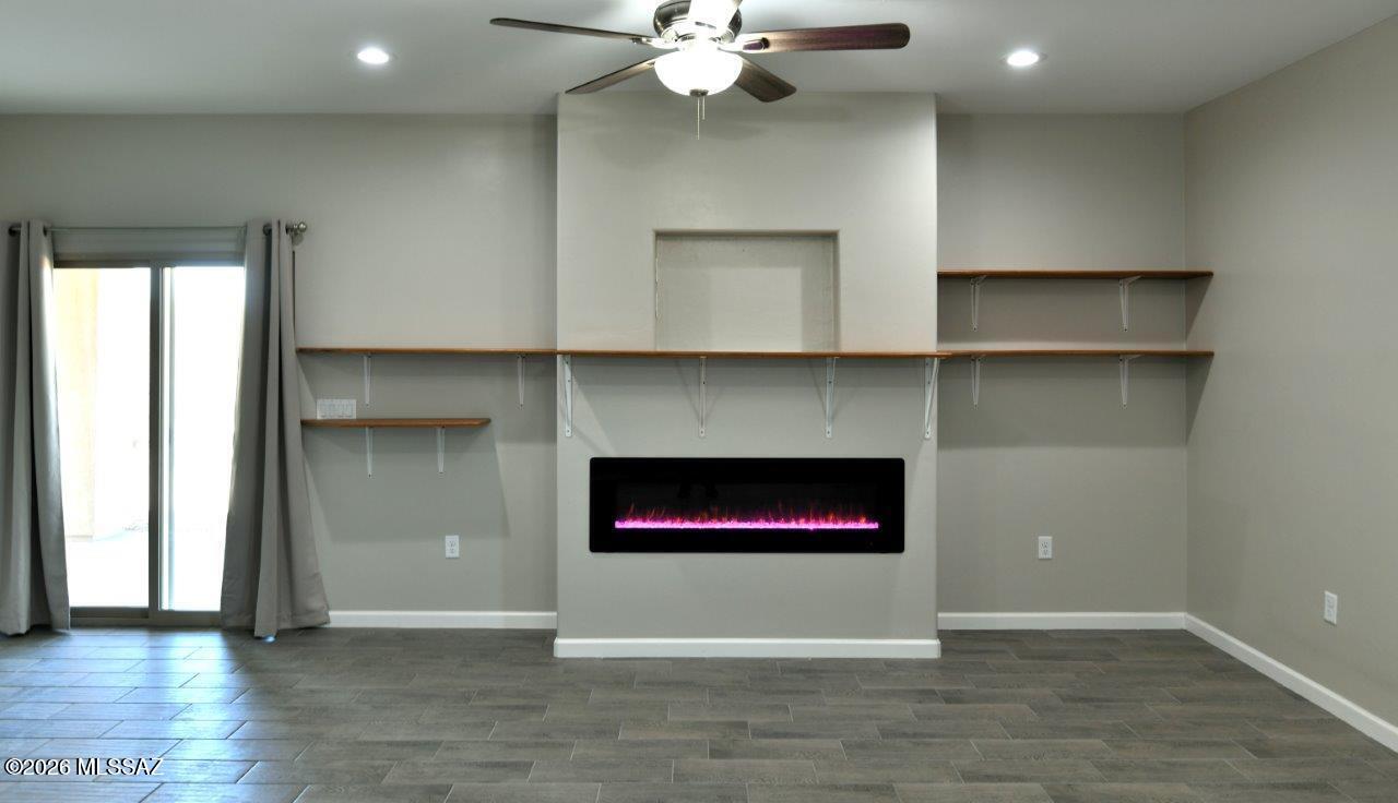 1091 North Vail View Road Vail, AZ 85641 - Photo 9 of 43 a view of an empty room with a fireplace and a window