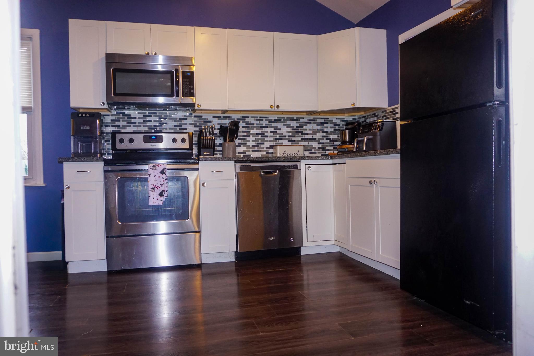 91 Mt Clement Avenue Pine Hill, NJ 08021 - Photo 11 of 27 a kitchen with stainless steel appliances a refrigerator and a stove top oven