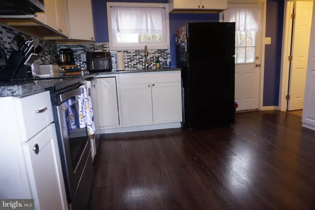 a kitchen with a refrigerator and a stove