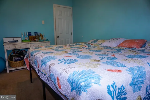 a bedroom with a bed and dresser