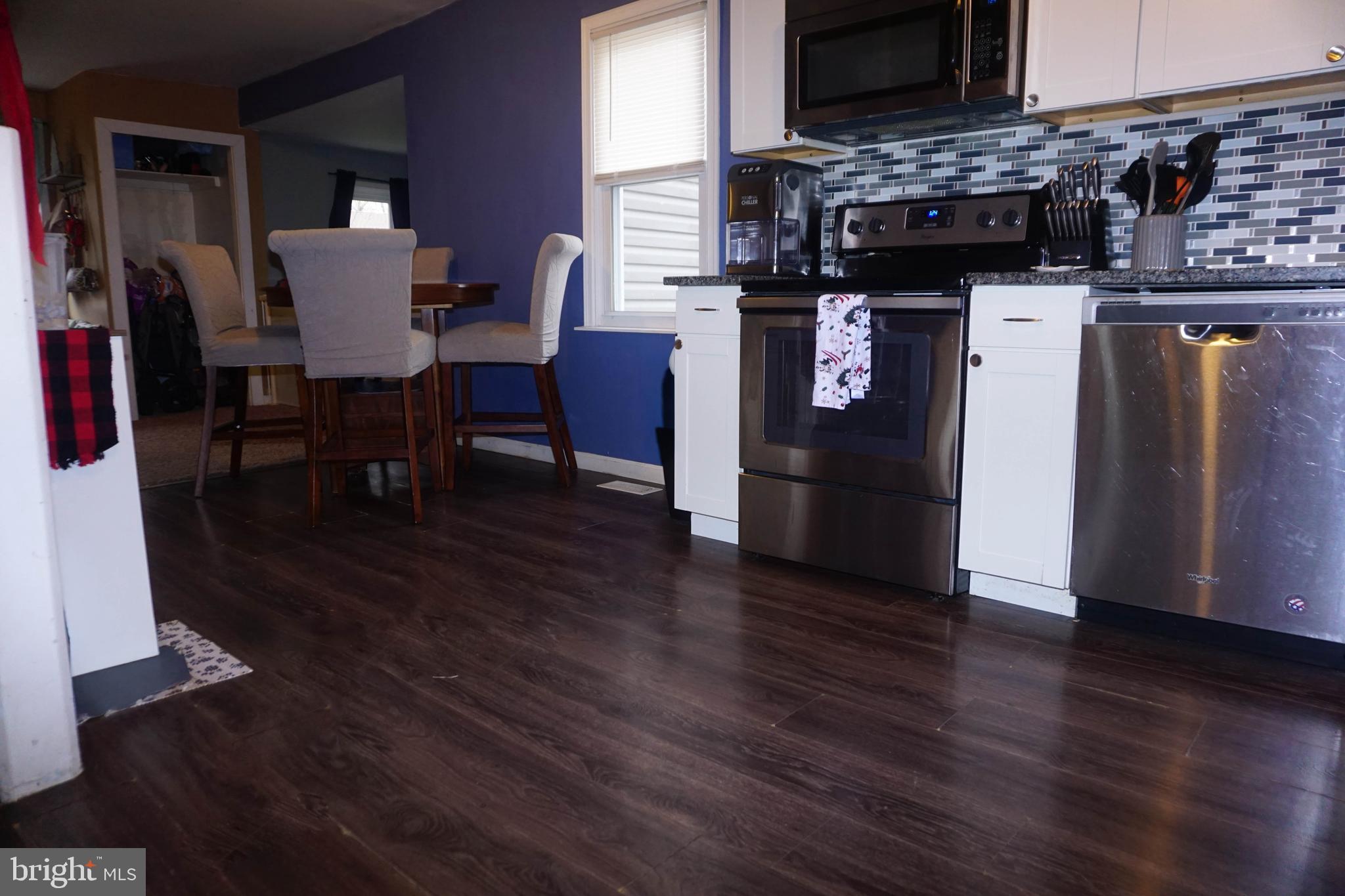 91 Mt Clement Avenue Pine Hill, NJ 08021 - Photo 9 of 27 a dining room with furniture and wooden floor