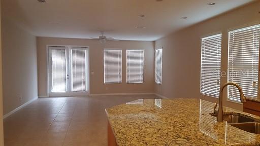 7652 Ripplepointe Way Windermere, FL 34786 - Photo 3 of 21 a bathroom with a granite countertop sink and a window