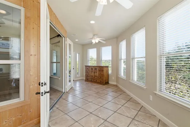 a view of a hallway with wooden floor and windows