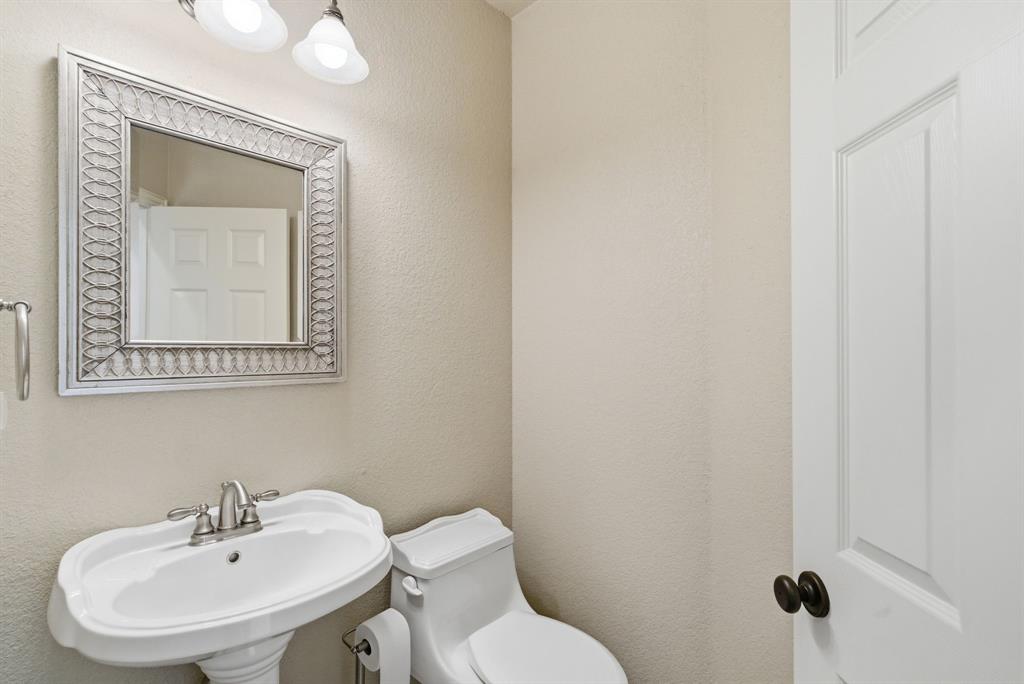 6525 Compass Way Bluff Dale, TX 76433 - Photo 22 of 40 a bathroom with a toilet sink and mirror