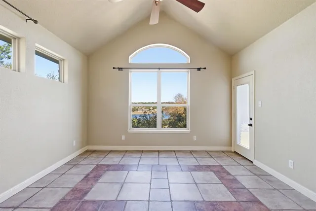 an empty room with a window and a shower