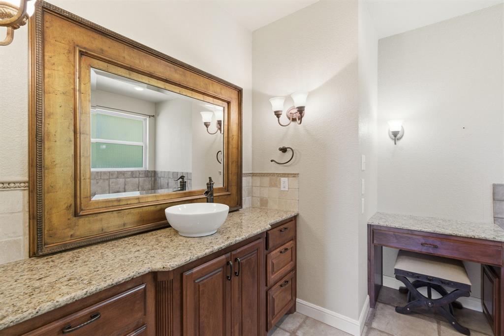 6525 Compass Way Bluff Dale, TX 76433 - Photo 28 of 40 a bathroom with a granite countertop sink and a mirror