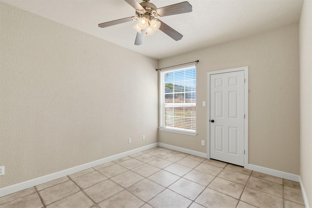 6525 Compass Way Bluff Dale, TX 76433 - Photo 30 of 40 an empty room with windows and fan