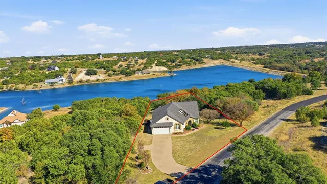 an aerial view of residential houses with outdoor space and swimming pool