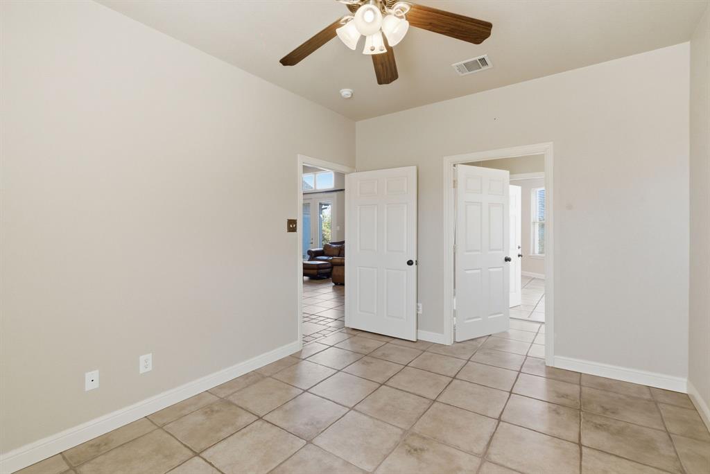 6525 Compass Way Bluff Dale, TX 76433 - Photo 31 of 40 an empty room with closet and a chandelier fan