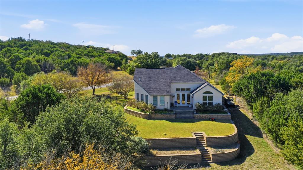 6525 Compass Way Bluff Dale, TX 76433 - Photo 40 of 40 a aerial view of a house with swimming pool and large trees