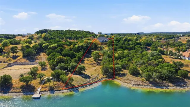 an aerial view of a houses with yard