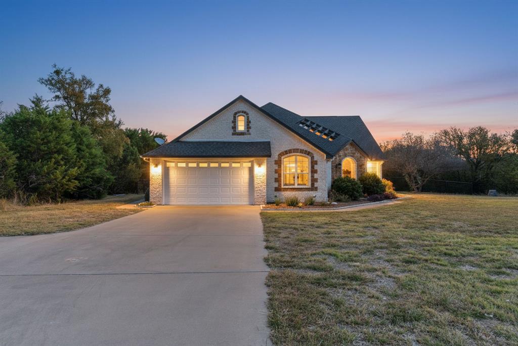 6525 Compass Way Bluff Dale, TX 76433 - Photo 5 of 40 a front view of a house with a yard